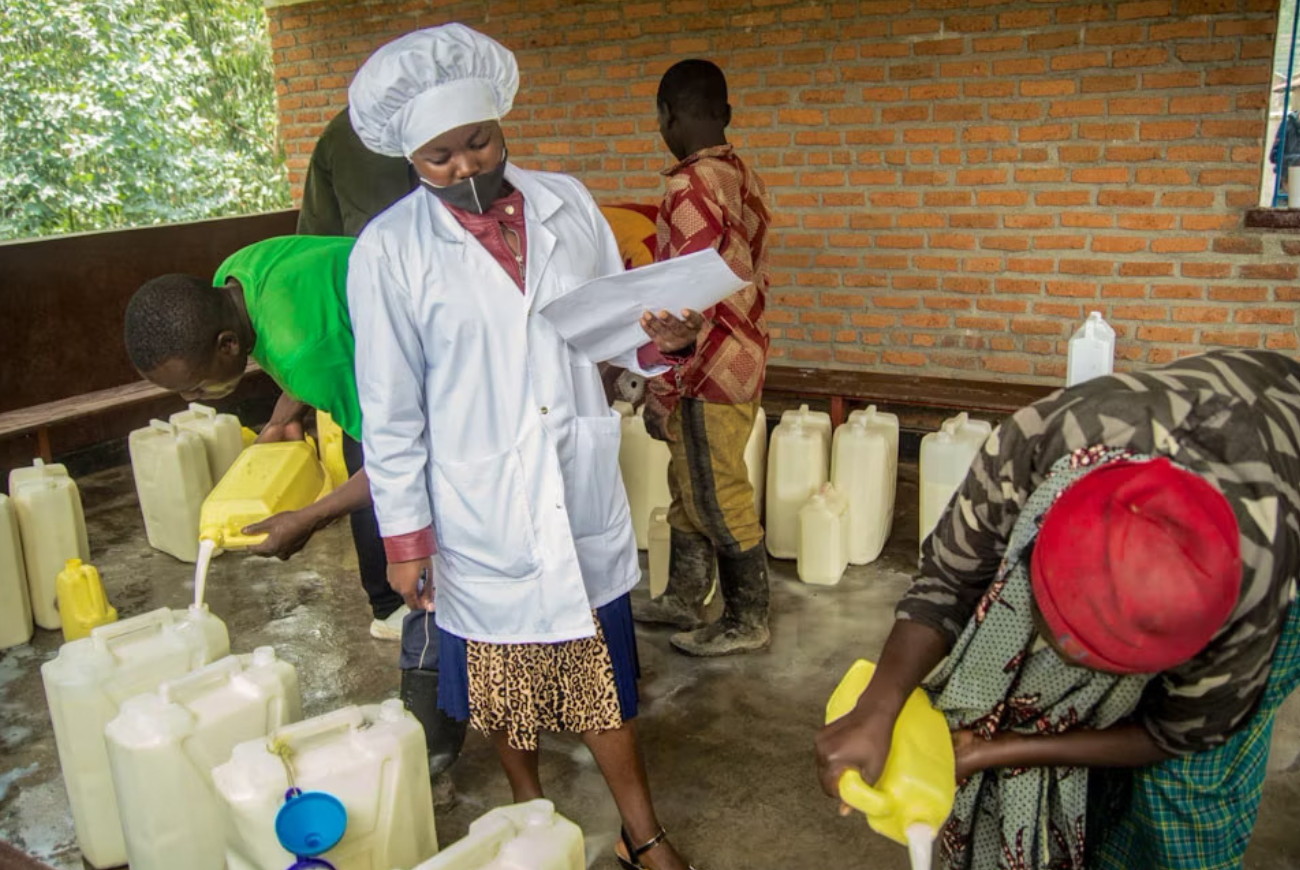 Rwandan dairy farmers deliver fresh milk to a local milk collection point.