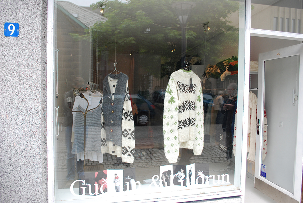 Caption Sweaters in a storefront window.