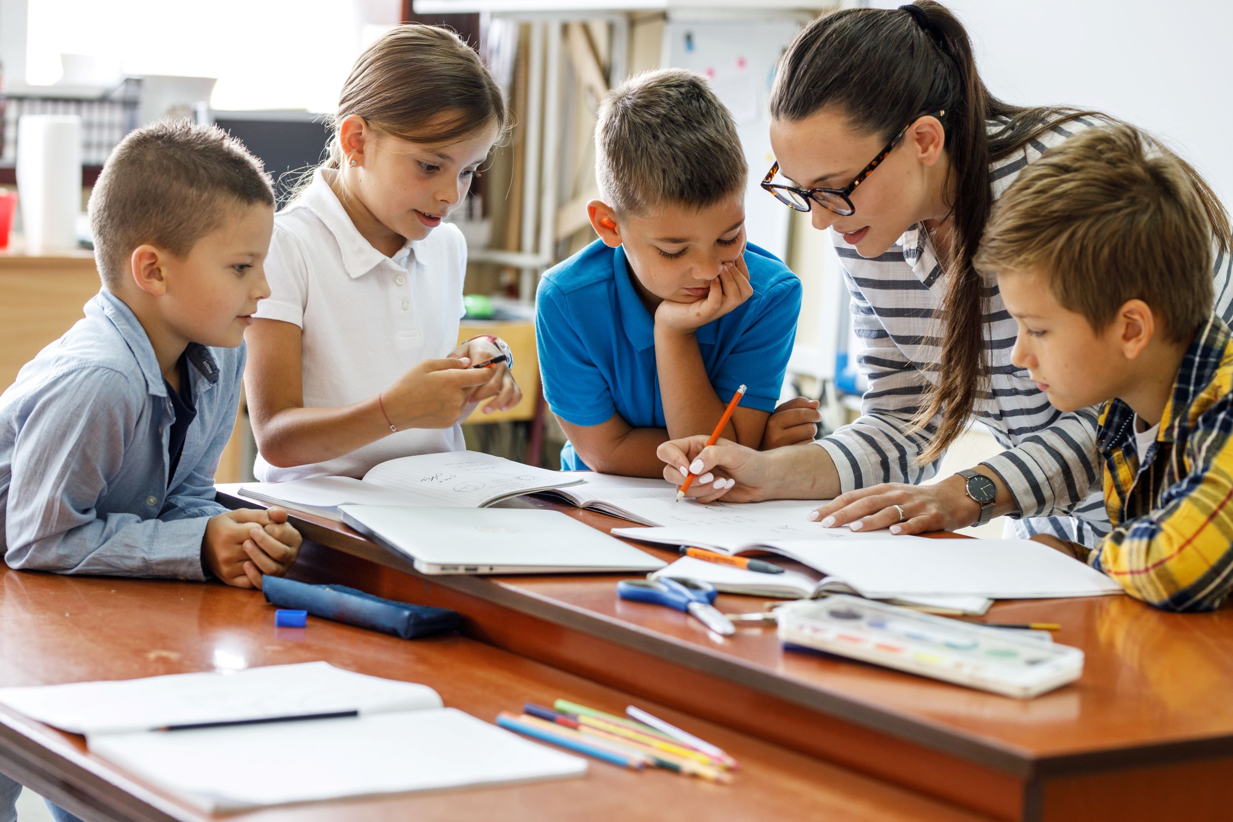 A teacher and students in a classroom.