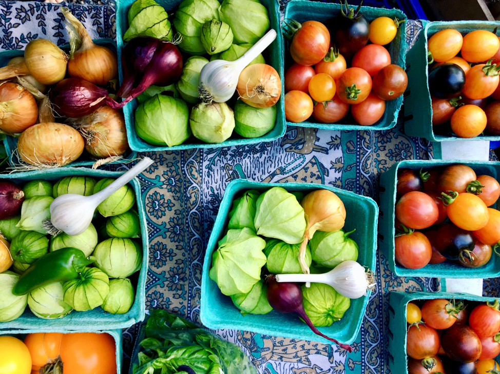 Local veggies are the best veggies. Various vegetables spread out on a table.