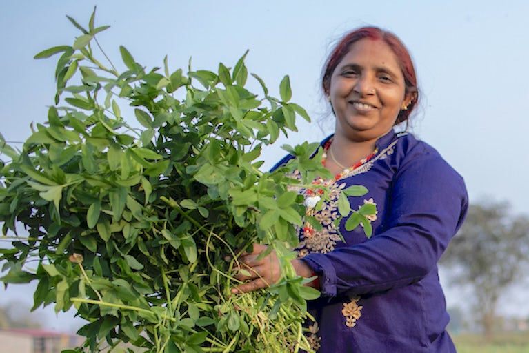 woman holding plant.